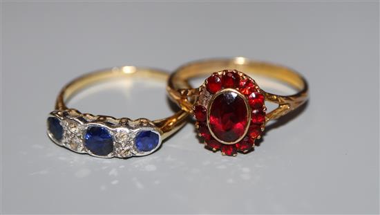 An early 20th century 18ct, sapphire and diamond set ring and a 9ct and garnet cluster ring.